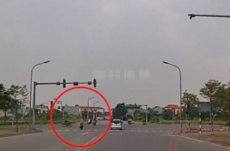 Clip: Vượt đèn đỏ đâm vào người khác, thanh niên đi xe máy suýt chui gầm ô tô